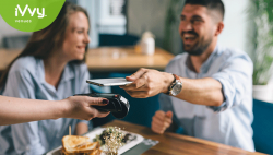 Man paying for meal using contact less pay